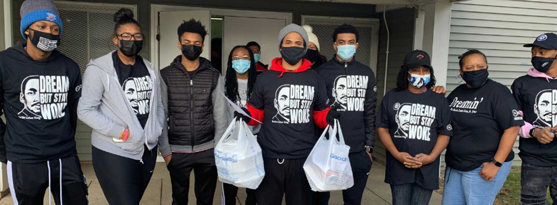 SUL members giving out food